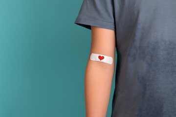Arm with Band Aid Featuring Red Heart Symbolizing Healing, Love, and Medical Care