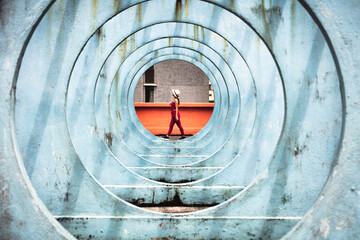 Woman walking at the end of circle shaped structure