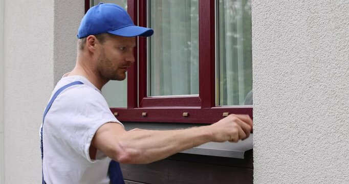 tinsmith installing new tin window sill for house exterior