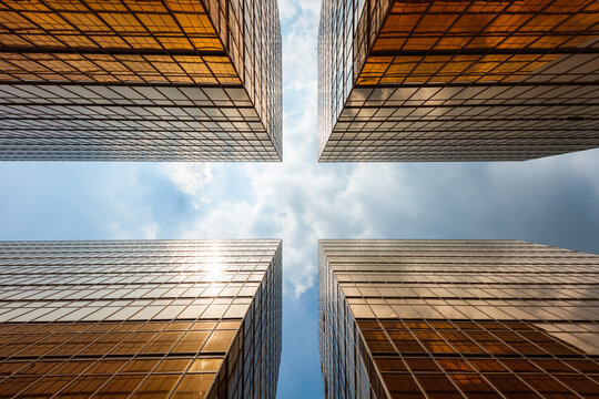 Fototapeta Low angle view of four buildings against blue sky, Hong Kong