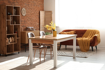 Interior of comfortable living room with table, sofa, chairs and shelving unit