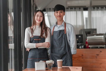 Bright atmosphere of success coffee shop owners smiling together in a friendly urban space