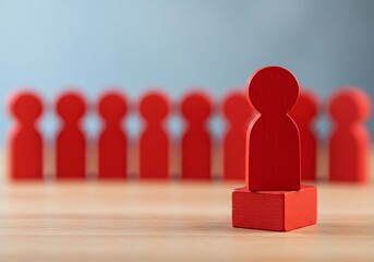 Red wooden human figures with one elevated, symbolizing leadership and standing out, representing team hierarchy, individual recognition, and a business concept.