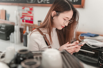 Young woman texting on phone, cozy coffee shop, lifestyle photography, indoor close-up, modern trends