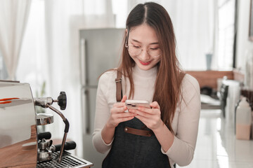 Young woman enjoys coffee while engaging with smartphone in cozy coffee shop atmosphere