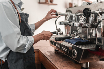 Barista crafting espresso in a cozy coffee shop a close-up of professional coffee culture