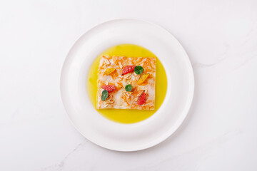 Colorful dessert with fresh fruits and a vibrant sauce on a white plate