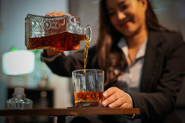 Closeup business woman holding a glass of whiskey