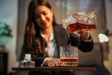 Closeup business woman holding a glass of whiskey