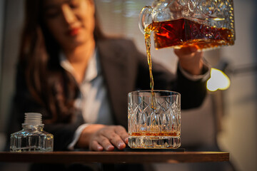 Closeup business woman holding a glass of whiskey