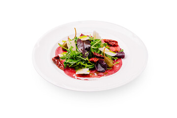 Fresh salad with beef carpaccio and mixed greens served on a white plate