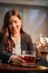 Closeup business woman holding a glass of whiskey