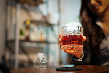 Closeup business woman holding a glass of whiskey