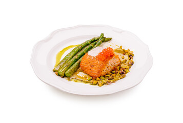 Salmon with asparagus and pistachio, beautifully plated in a restaurant