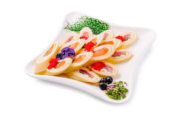 An elegant appetizer featuring thin pancake rolls filled with smoked salmon, cream cheese, and...