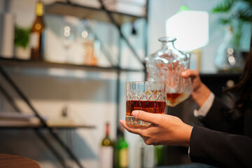 Closeup business woman holding a glass of whiskey