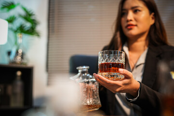 Closeup business woman holding a glass of whiskey