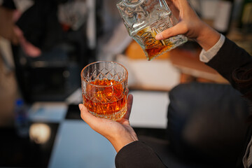 Closeup business woman holding a glass of whiskey