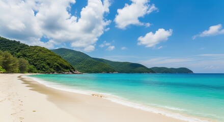 A serene tropical beach with turquoise water and lush green mountains under a cloudy sky