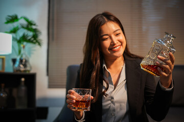 Closeup business woman holding a glass of whiskey