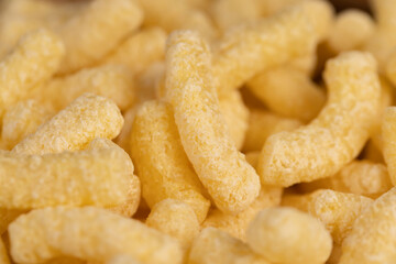 corn sticks from flour, a large number of corn sticks for eating or making breakfast with milk, corn sticks in a wooden bowl, close up