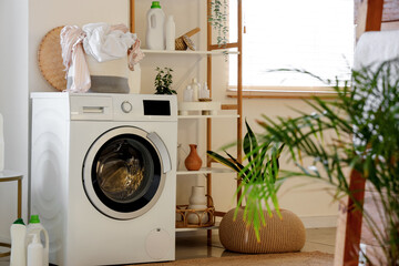 Interior of modern bathroom with washing machine