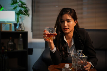 Closeup business woman holding a glass of whiskey