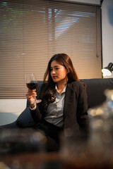  Closeup business woman holding a glass of wine