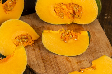cut juicy pumpkin for cooking closeup, cut into pieces pumpkin in the kitchen