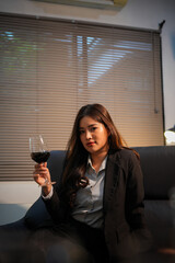 Closeup business woman holding a glass of wine