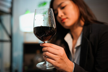 Closeup business woman holding a glass of wine