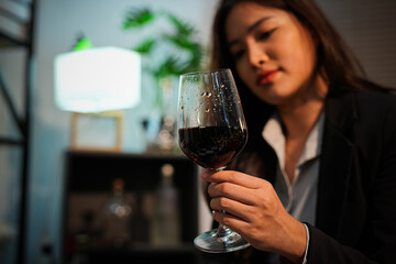 Closeup business woman holding a glass of wine