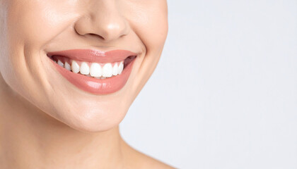 Obraz premium Close-up of a woman's teeth smiling confidently on isolated white background.