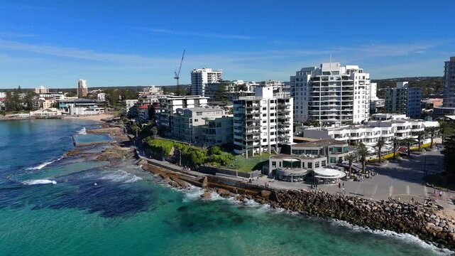 Aerial coastal orbit establishing of Cronulla city with beach, skyline and turquoise water, Sydney NSW Australia