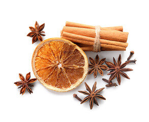 Star anise with cinnamon sticks, dried orange and cloves on white background, top view
