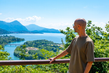 young man Exploring Lake Maggiore, Tourist enjoys leisurely walk along Montorfano village, Hiking...
