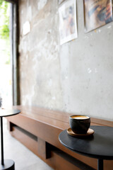 Cup of milk latte coffee on table by the street.