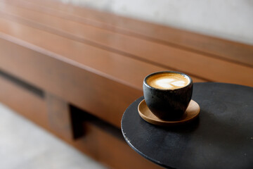 Cup of milk latte coffee on table by the street.