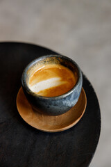Cup of milk latte coffee on table by the street.
