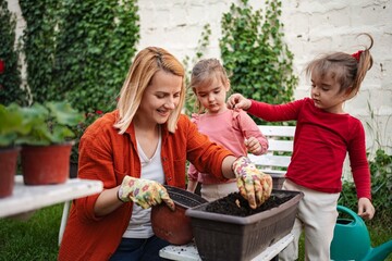 Gardening joy with children in a sunny backyard