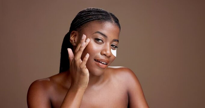 Woman, eye patch and results with face in studio for dark circles, cosmetics or hydration on background. African girl, model and portrait with space for dermatology, skincare and beauty in Nigeria