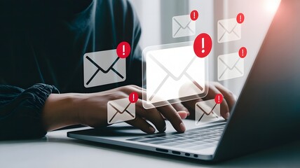 Person working on laptop with multiple email notifications showing urgent alerts