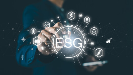 A person interacts with a digital interface displaying ESG, surrounded by icons representing sustainability, energy, and environmental concepts.