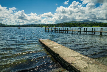 Wind-driven waves glisten in the summer light on Windermere’s rippling surface, seen from a...