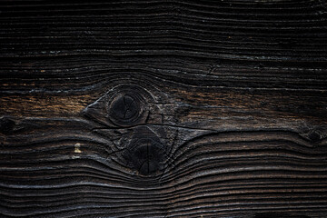Brown wooden background with detailed wood structure with knots and nail holes. Dark wood texture background surface with old natural pattern