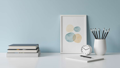 Interior styled desk with books and decor in front of light blue wall