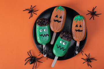Cakes with Frankenstein and scary pumpkin faces for Halloween party