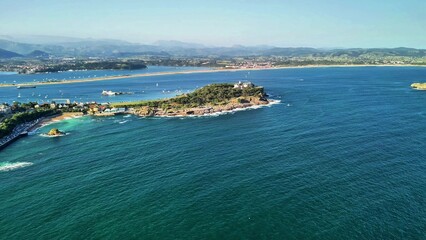 A stunning and breathtaking aerial shot of a picturesque coastal island showcasing natures beauty and vibrant waters