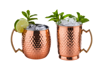 Copper mugs hold drinks with ice and mint sprigs, accompanied by lime halves. This photo suggests a festive occasion, suitable for use in content about food or beverages.
