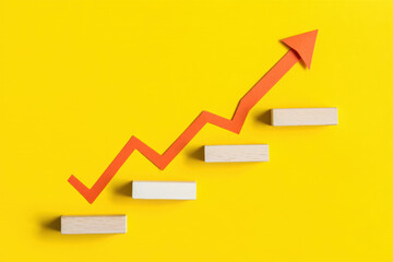 Ascending Growth Chart with Wooden Blocks on Yellow Background Depicting Business Success and Progress, Representing Financial Improvement and Positive Trends